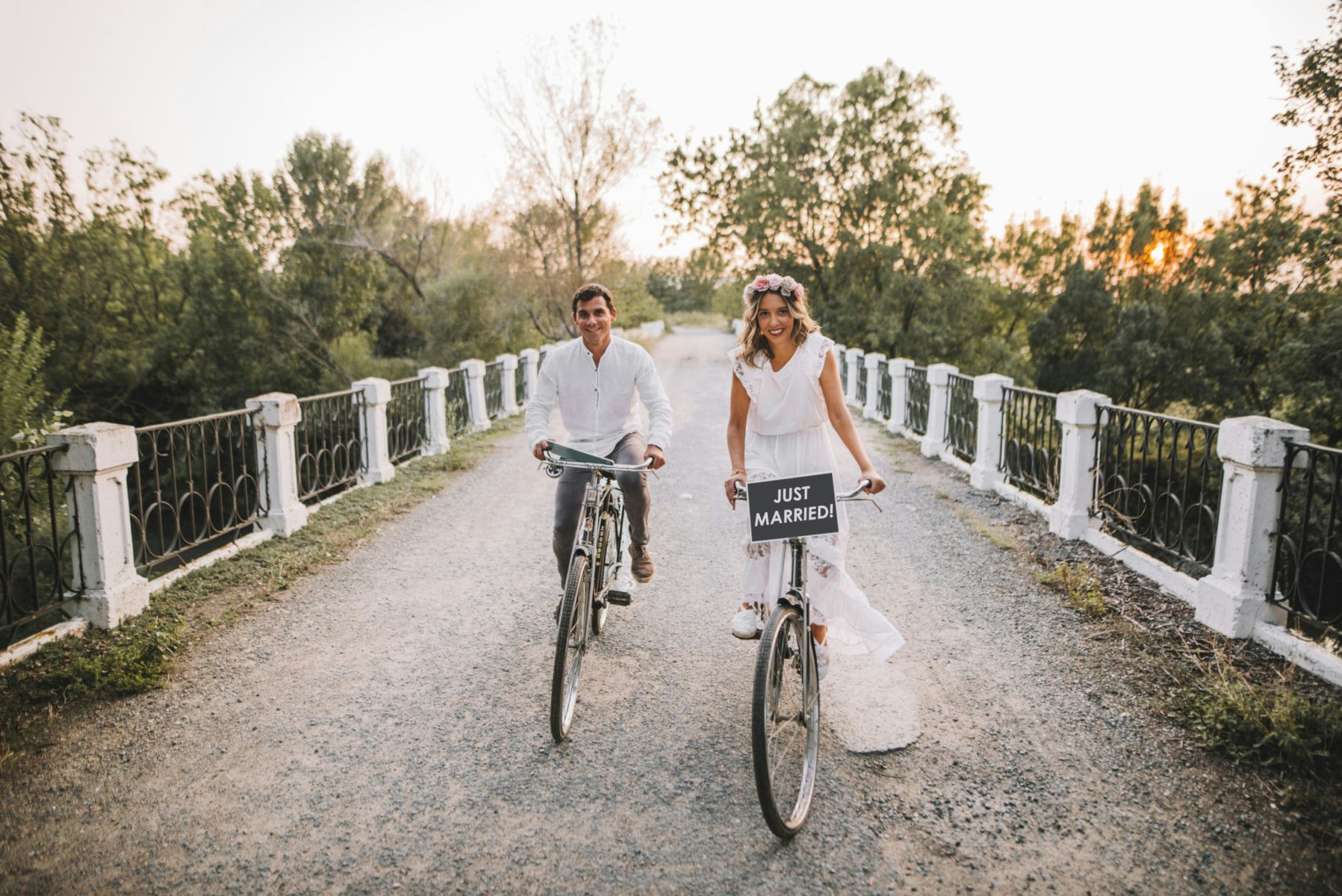 A bride and grooom on bicycles