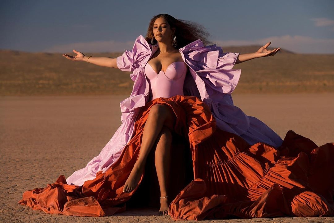 Beyoncé wearing a pink dress in the desert in Arizona