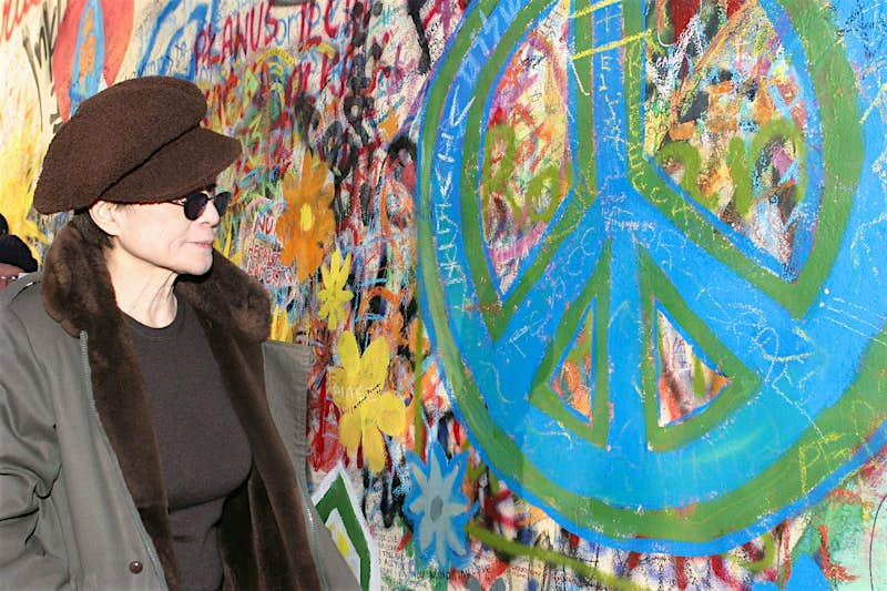 Travel News - Yoko Ono at Lennon Wall in Prague Yoko Ono looks at a peace symbol on the John Lennon Peace Wall in Prague.